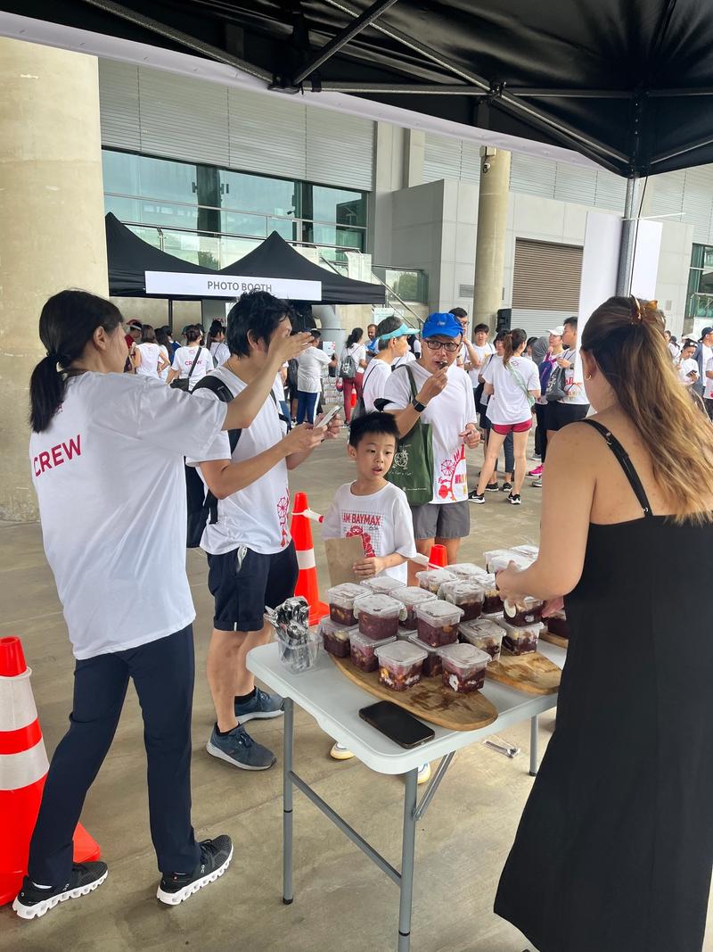 Serving açaí cups to a crowd at a community event