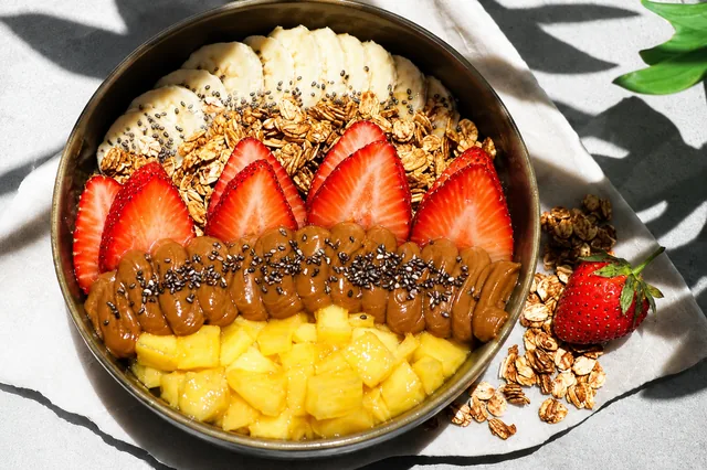 Signature açaí bowl layered with strawberry, mango, banana and granola